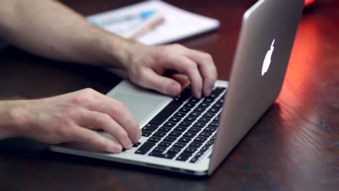 Hands Typing On Macbook