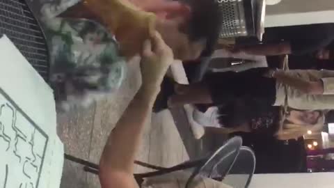 Girl smaks guy in the face with pizza