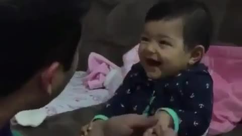 Baby teases Dad