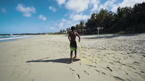 A kid walking on the beach