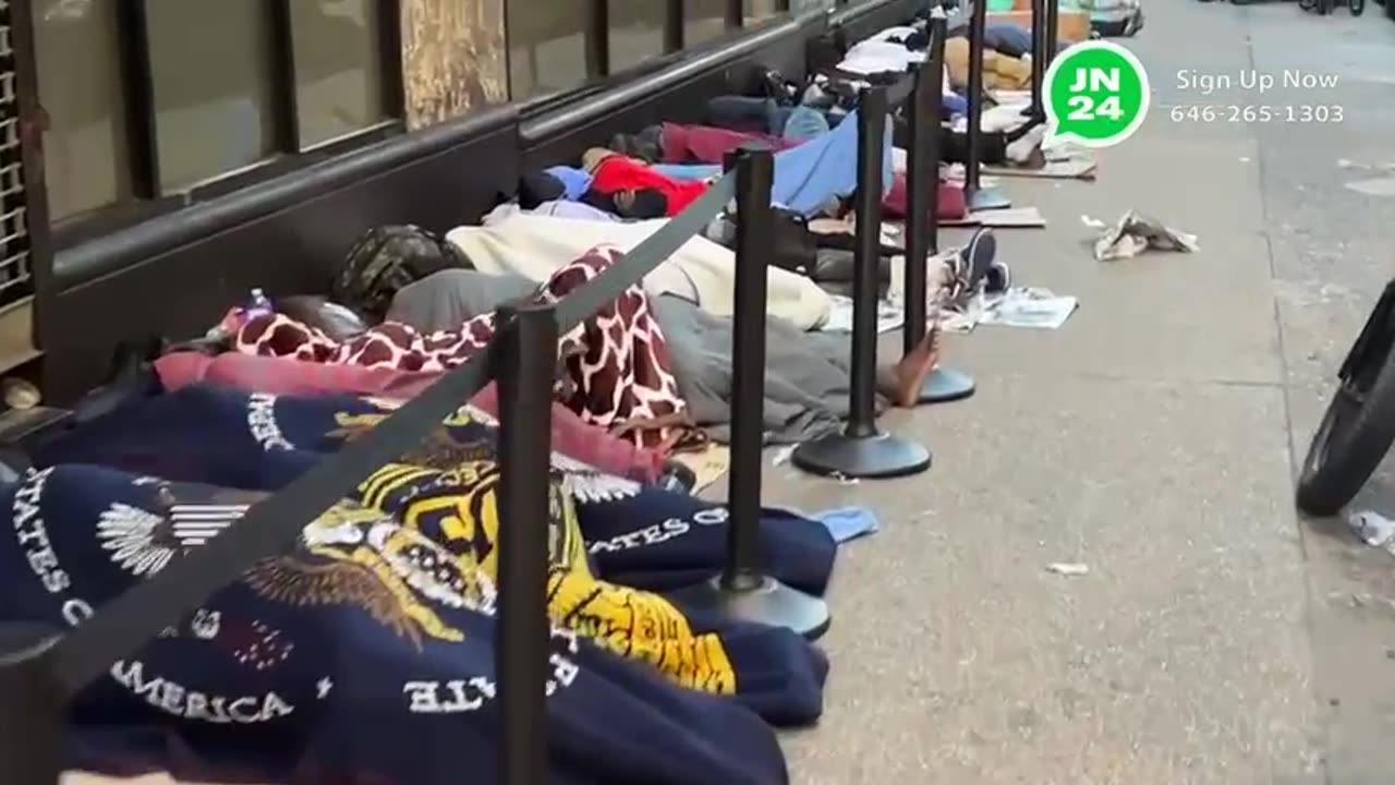 dozens of migrants sleeping on cardboard outside the iconic Roosevelt Hotel in Midtown Manhattan