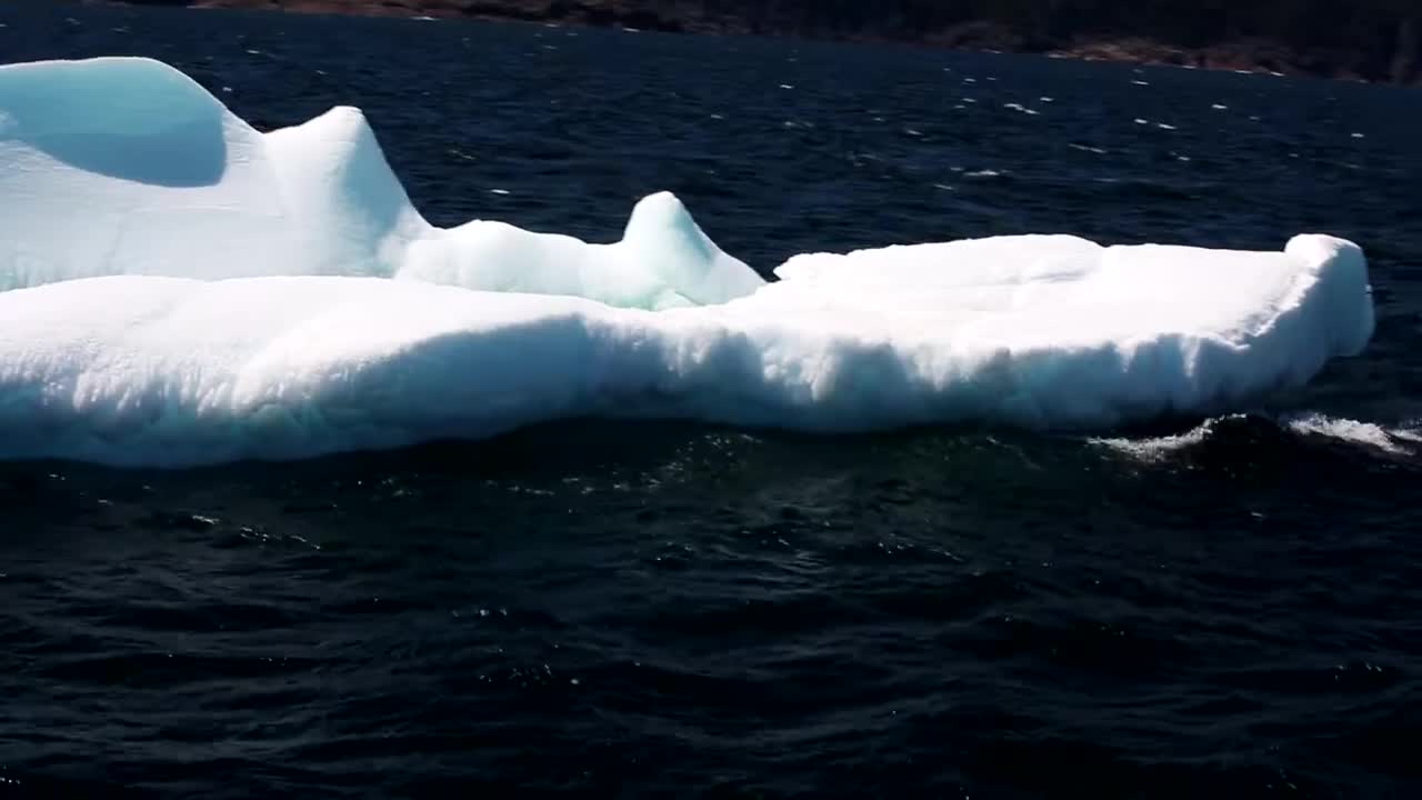 iceberg moving with green color underwater