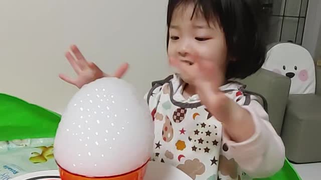 A pretty kid playing with dry ice