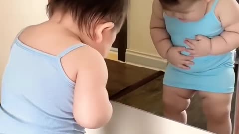 Cute boy's funny movement on mirror