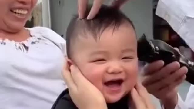 Child laughing at his haircut