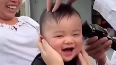 Child laughing at his haircut