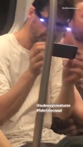 A man with purple lights on his glasses on train