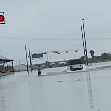 Water skiing down flooded street from Tropical Storm Imelda