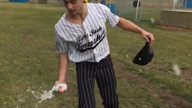 Guy in baseball uniform cracks beer over head