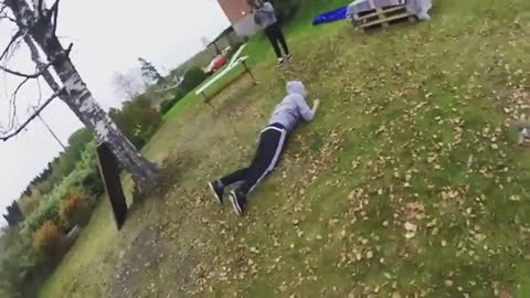 Gymnastics swing from tree onto butt