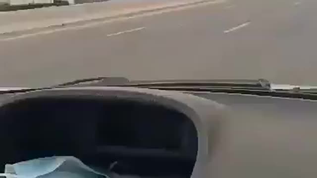 Very Dangerous: A reckless truck driver is walking against a highway at high speed