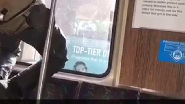 Guy black hat brown satchel pull ups subway train