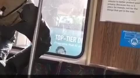 Guy black hat brown satchel pull ups subway train