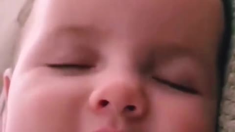 Cute baby calling his mom while sleeping