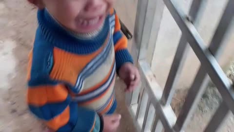 baby crying outside the gate waiting for mom