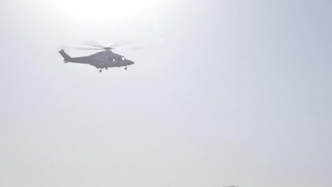 A Helicopter On Flight Leaving An Airfield