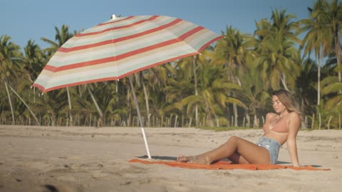 Young woman sunbathing on the beach