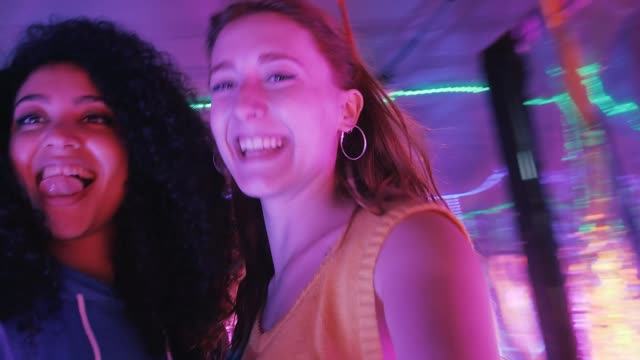 Pair of female friends having fun on a night out