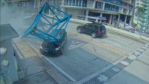 A piece of a crane falls on a car