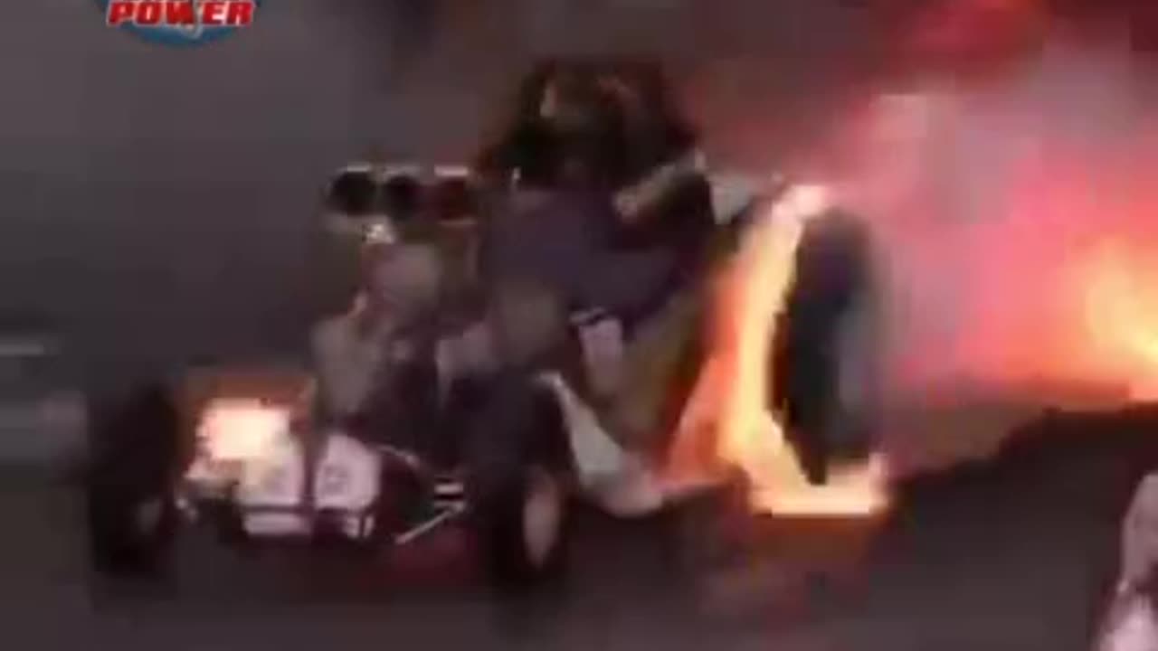 Dragster sends off flames into smoke