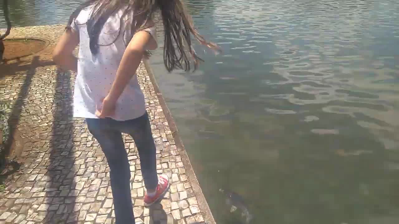 Child watching fish in the park