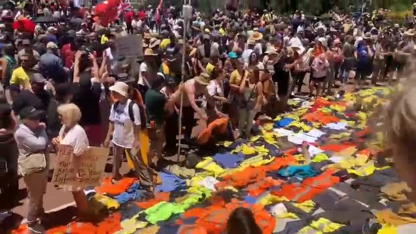 Patriots in Australia laying down their work uniforms on the steps of parliament.