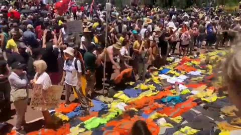 Patriots in Australia laying down their work uniforms on the steps of parliament.