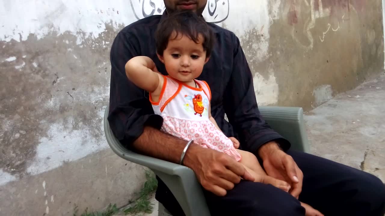 A very cute little baby talking on mobile phone with his uncle