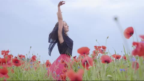 Girl dancing happily in a field of flowers