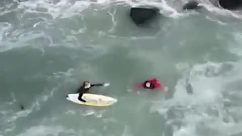 Surfers rush to rescue fishermen knocked off jetty