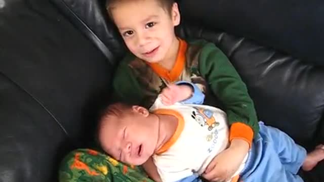 Big Brother Holds Baby Brother