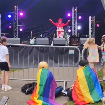 A drag queen dressed in blood throws tampons to children