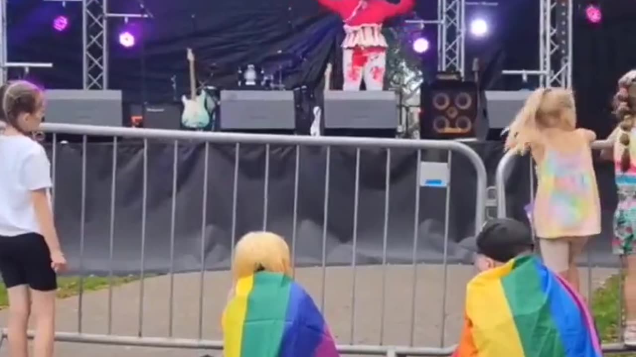 A drag queen dressed in blood throws tampons to children