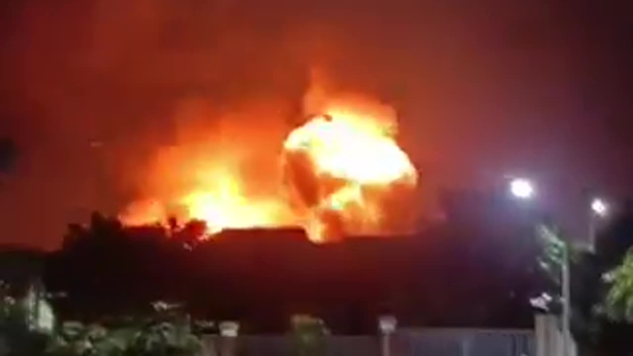 At a military base in Indonesia, a BC warehouse burns and detonates.