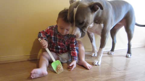 Baby gives dog peanut butter