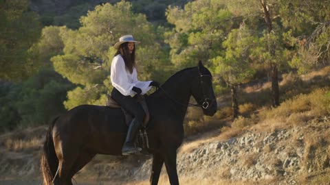 Side view of positive professional Caucasian equestrian talking to horse