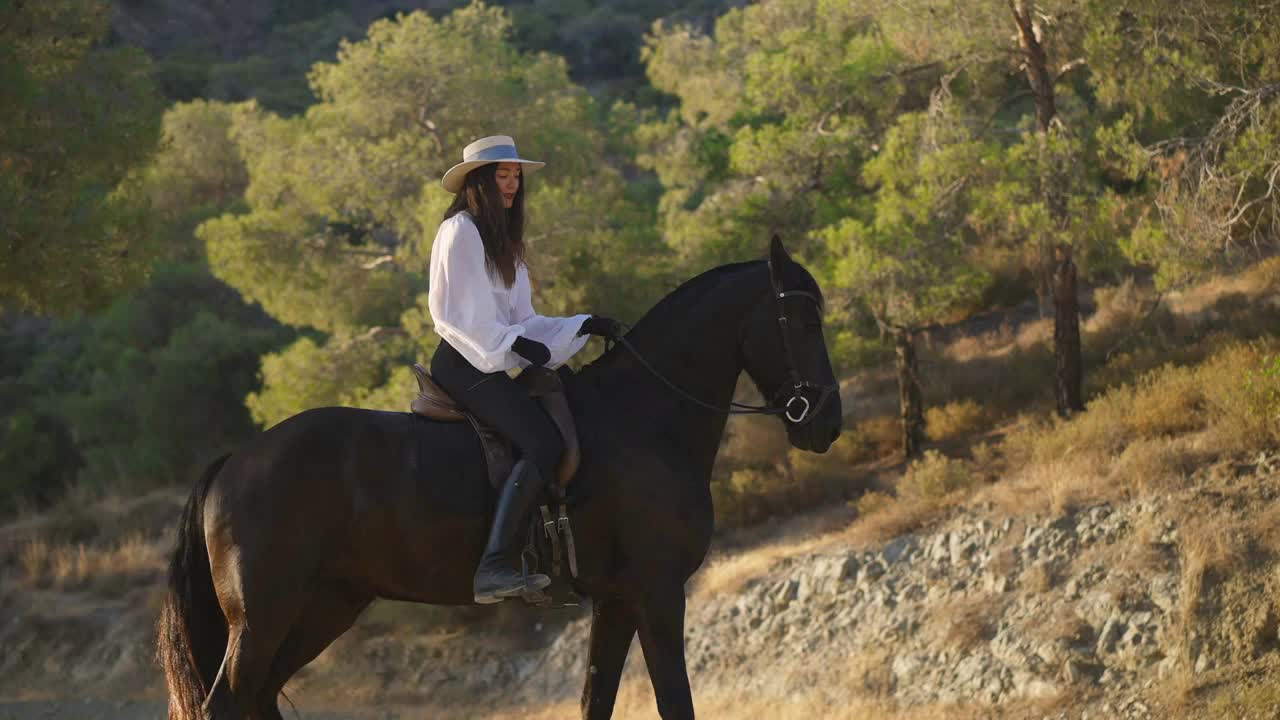 Side view of positive professional Caucasian equestrian talking to horse