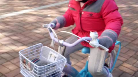 Baby practice riding a bicycle