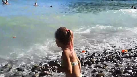 Little girl catches waves