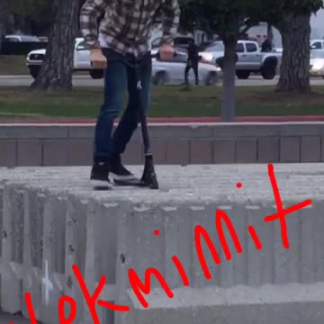 Guy in checkered shirt jumping on scooter consistently