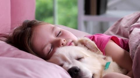 Little girl asleep with her dog