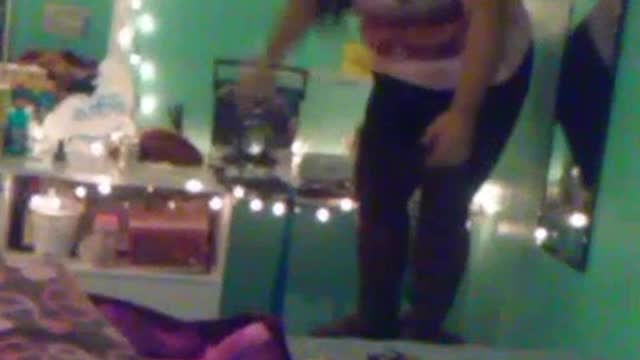 Pink shirt girl jumps off chair onto bed and falls off