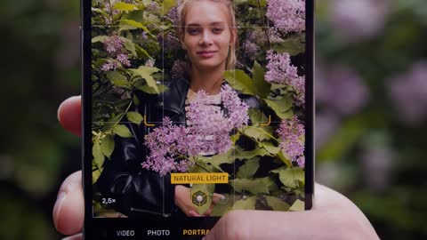 close-up-of-a-person-taking-photos-of-a-woman-on-a-cellphone