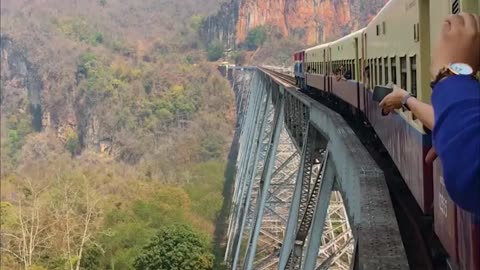 ON A TRAIN TRAVELLING IN MYANMAR 100M UP ON A BRIDGE