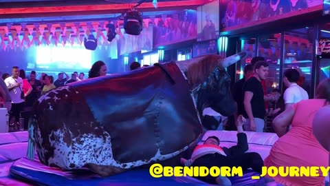 Boy in black clothes and Girl in pink clothes Riding on a Bull in Benidorm _ Bull 🐂 Riding 4K