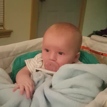 3 month old working to put pacifier back in his mouth too cute