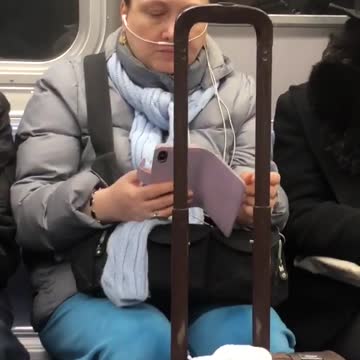 Woman wears her earphones like a nasal cannula