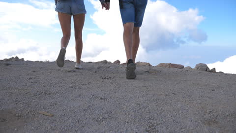 Young Couple of Tourists with Backpacks Running to the Edge of Beautiful Canyon and Victoriously