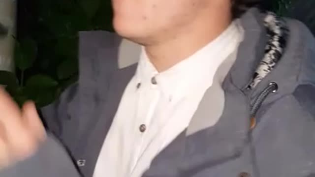 Music guy grey jacket tossing bong and breaking it