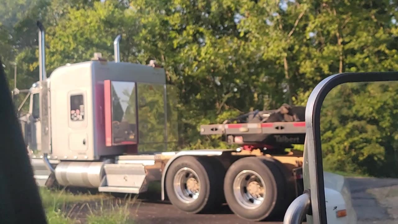 KENWORTH W 900 DRIVES OFF INTO THE SUNSET